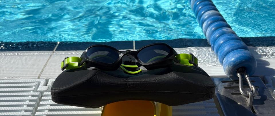 Effortless Swimming Flex Swim goggles on the edge of the pool